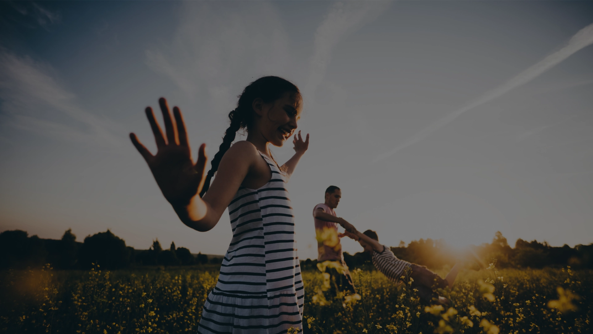 Daughter, son and dad playing in a farmers field