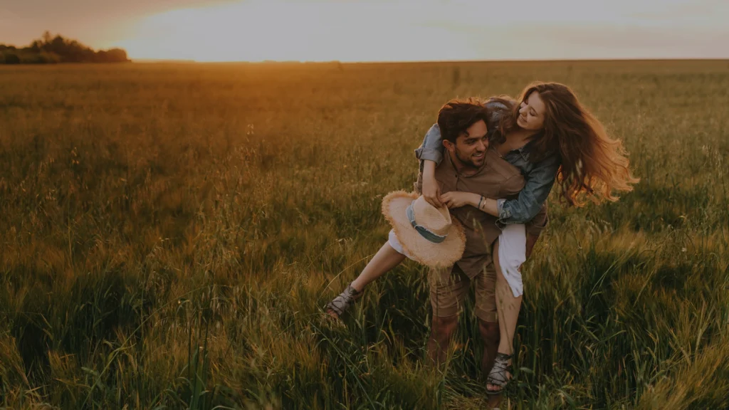 Man and wife couple in a farmers field hugging